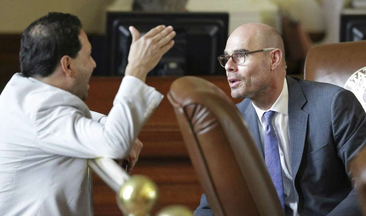 State Rep. Dennis Bonnen, R-Angleton, (right) discusses issues with Rep. Poncho Nevarez, D-Eagle Pass, as property tax legislation is considered on the floor of the House in May. On Thursday, Bonnen’s committee approved a controversial property tax rollback bill that is now headed to the House, where its chances of passing are much higher than they were during the regular session.