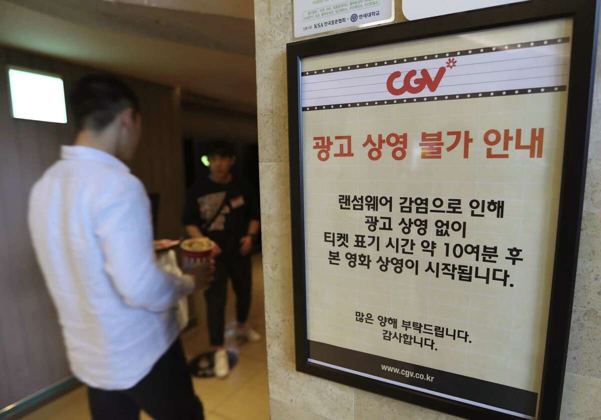 A customer walks by the notice about "ransomware" at CGV theater in Seoul, South Korea, Monday, May 15, 2017. The letters read "Due to ransomware affection, we are unable to screen advertisement. The movie is going to start 10 minutes after the ticket time." (AP Photo/Lee Jin-man)