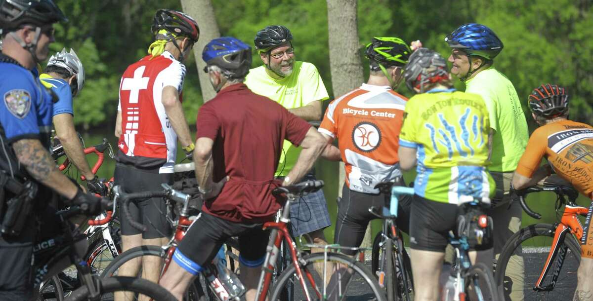 Cyclists stop at Young's Field Riverwalk to talk with Mayor David Gronbach, center, during New Milford’s second annual Bike to Work event Friday.