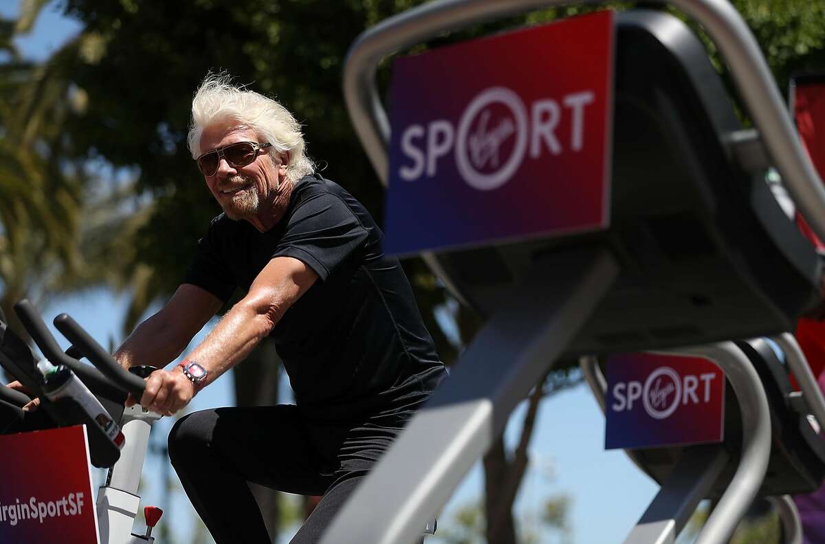 SAN FRANCISCO, CA - MAY 18: Sir Richard Branson rides an exercise bike during a news conference to announce the launch of Virgin Sport on May 18, 2017 in San Francisco, California. Virgin Group founder Sir Richard Branson announced Virgin Sport San Francisco, a half marathon run and fitness festival that is scheduled for October 14. (Photo by Justin Sullivan/Getty Images)