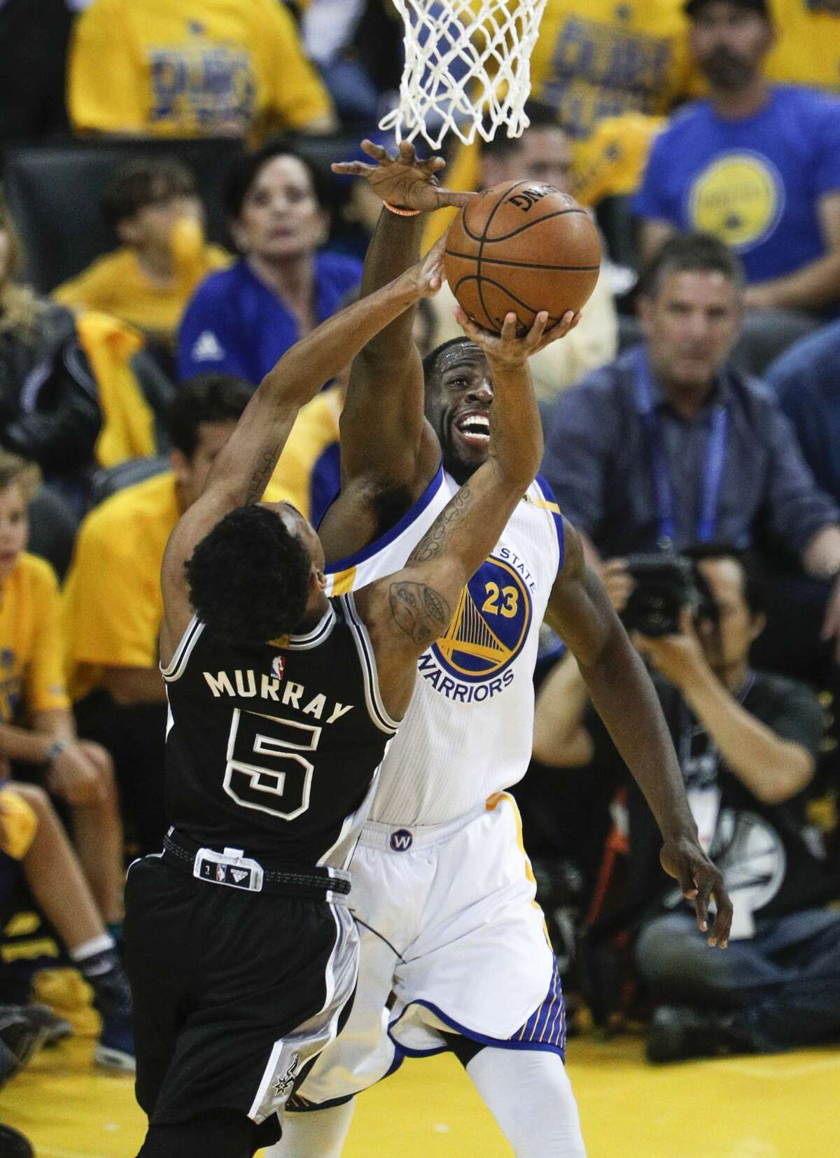 Golden State Warriors' Draymond Green blocks a San Antonio Spurs' Dejounte Murray shot in the first quarter during Game 2 of the 2017 NBA Playoffs Western Conference Finals at Oracle Arena on Tuesday, May 16, 2017 in Oakland, Calif.