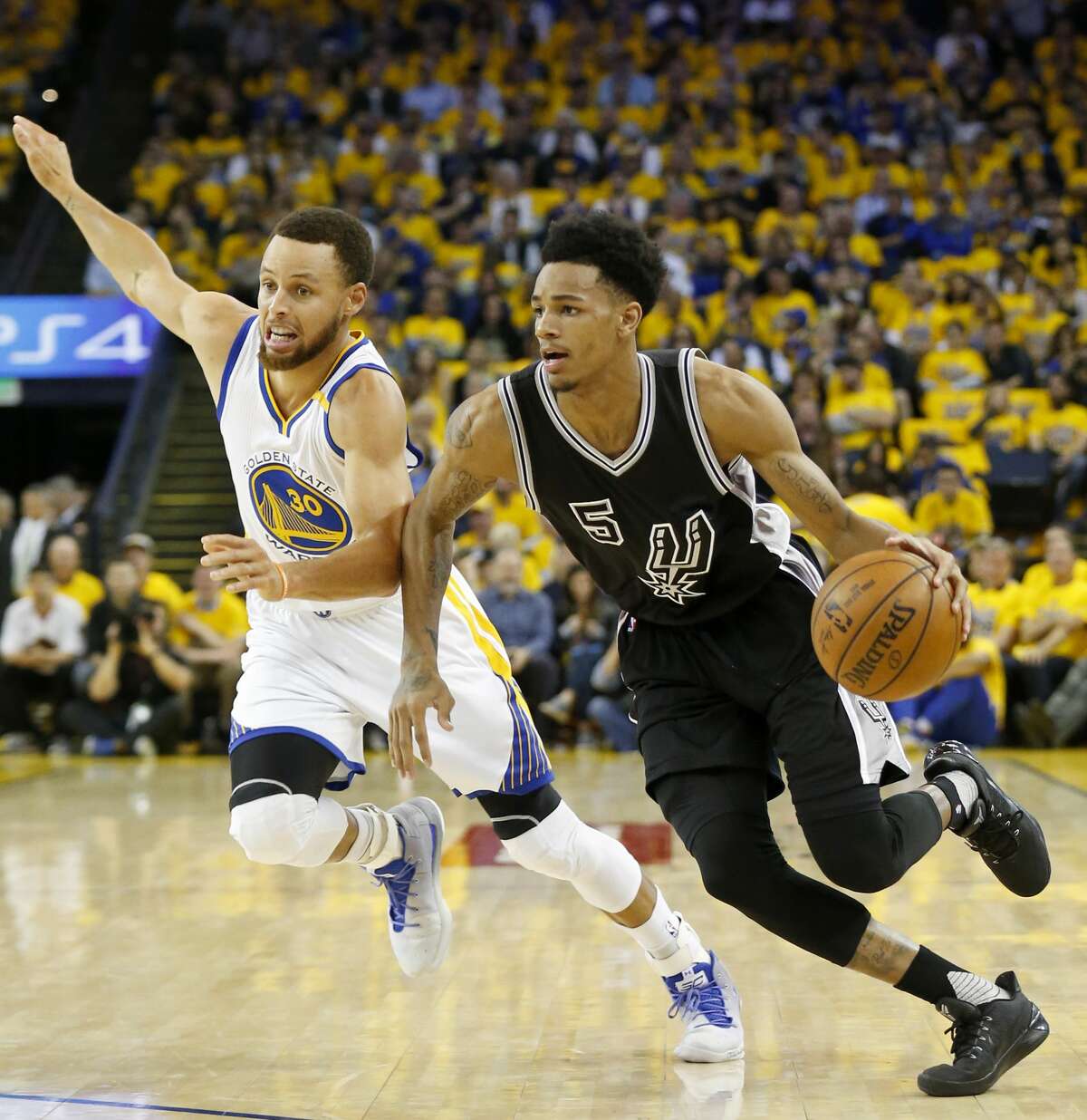San Antonio Spurs' Dejounte Murray looks for room around Golden State Warriors' Stephen Curry during first half action in Game 2 of the Western Conference Finals held Tuesday May 16, 2017 at Oracle Arena in Oakland, CA.