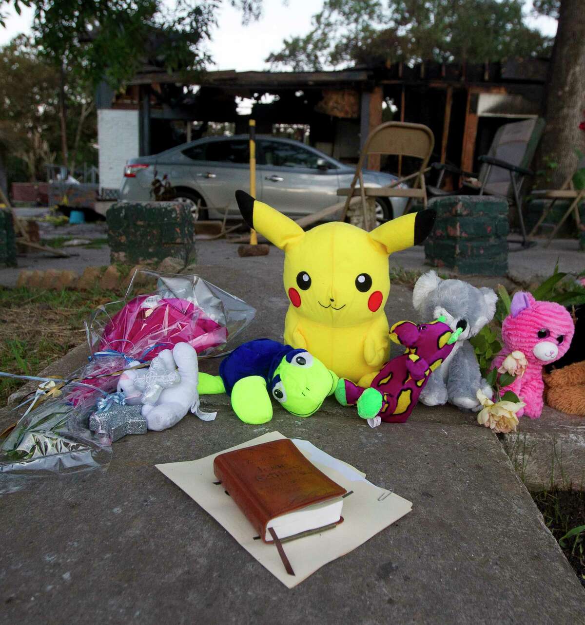 A make-shift memorial is seen in front of the home where a two-story house fire Friday morning killed three children on Johnson Road, Saturday, May 13, 2017, in the community of Tamina, just east of The Woodlands.