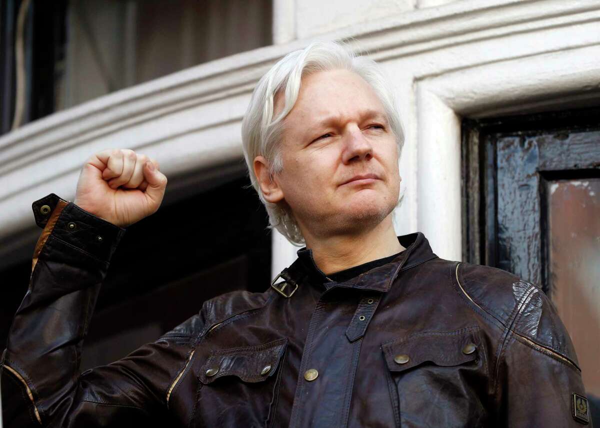 Julian Assange greets supporters outside the Ecuadorian embassy in London, Friday May 19, 2017. Sweden's top prosecutor says she is dropping an investigation into a rape claim against WikiLeaks founder Julian Assange after almost seven years. Assange took refuge in Ecuador's embassy in London in 2012 to escape extradition to Sweden to answer questions about sex-crime allegations from two women. (AP Photo/Frank Augstein)