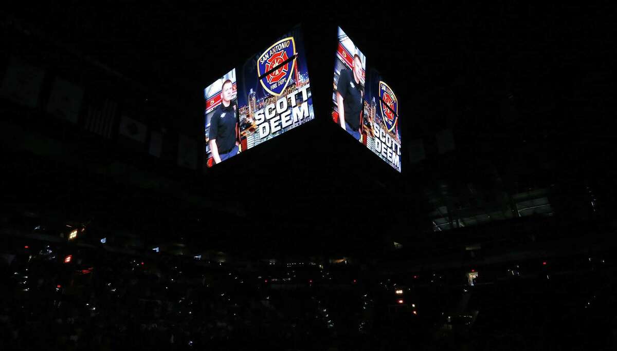 A moment of silence is held for San Antonio Fire Department Firefighter Scott Deem before the San Antonio Stars and Phoenix Mercury game Friday May 19, 2017 at the AT&T Center. Deem died yesterday while battling a fire at Ingram Square.