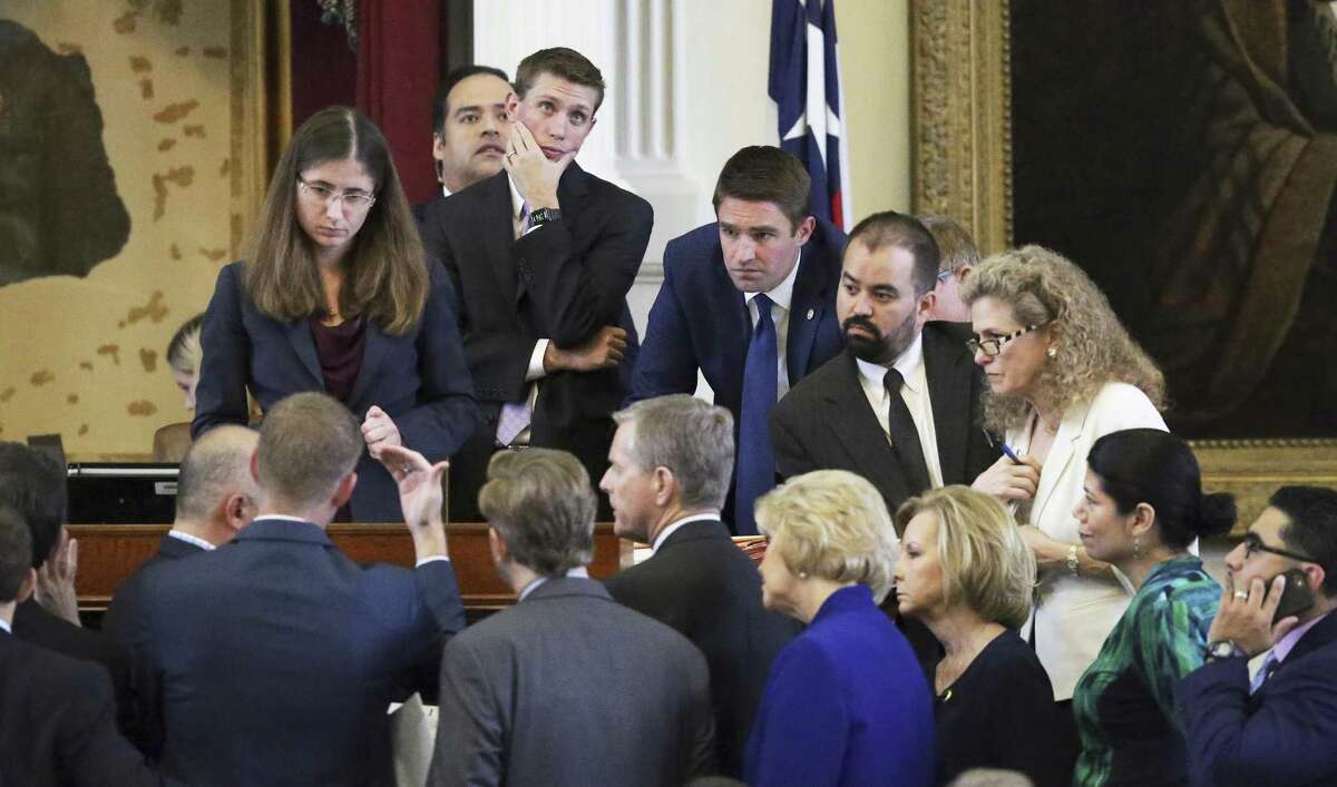 A point of order brings representatives to the dais as lawmakers in the House of Representatives debate points about fetal remains Friday at the Texas Capitol. The House tentatively passed Senate Bill 8 after more than five hours of often emotional and testy debate.