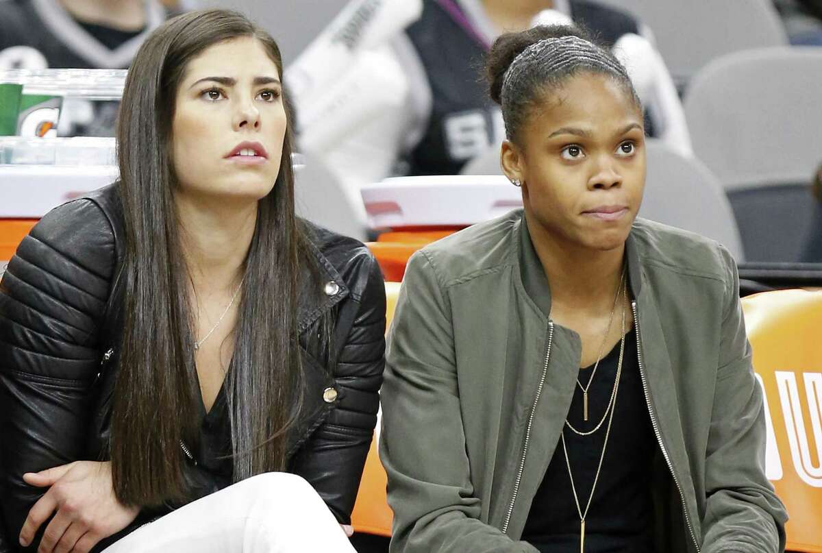 Injured Stars players Kelsey Plum (left) and Moriah Jefferson watch first half action against the Phoenix Mercury from the bench on May 19, 2017 at the AT&T Center.