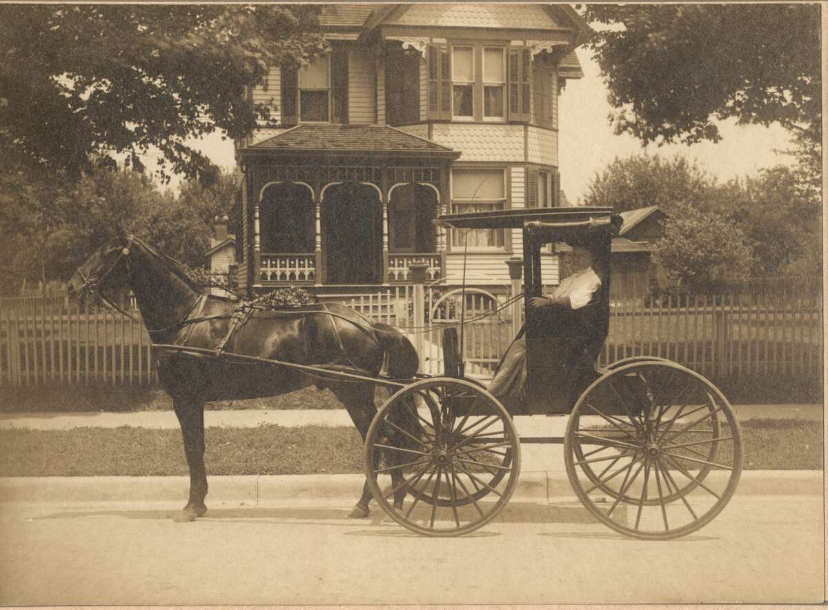 The photograph shows Phoebe Montgomery in a buggy in front of the house circa 1900.