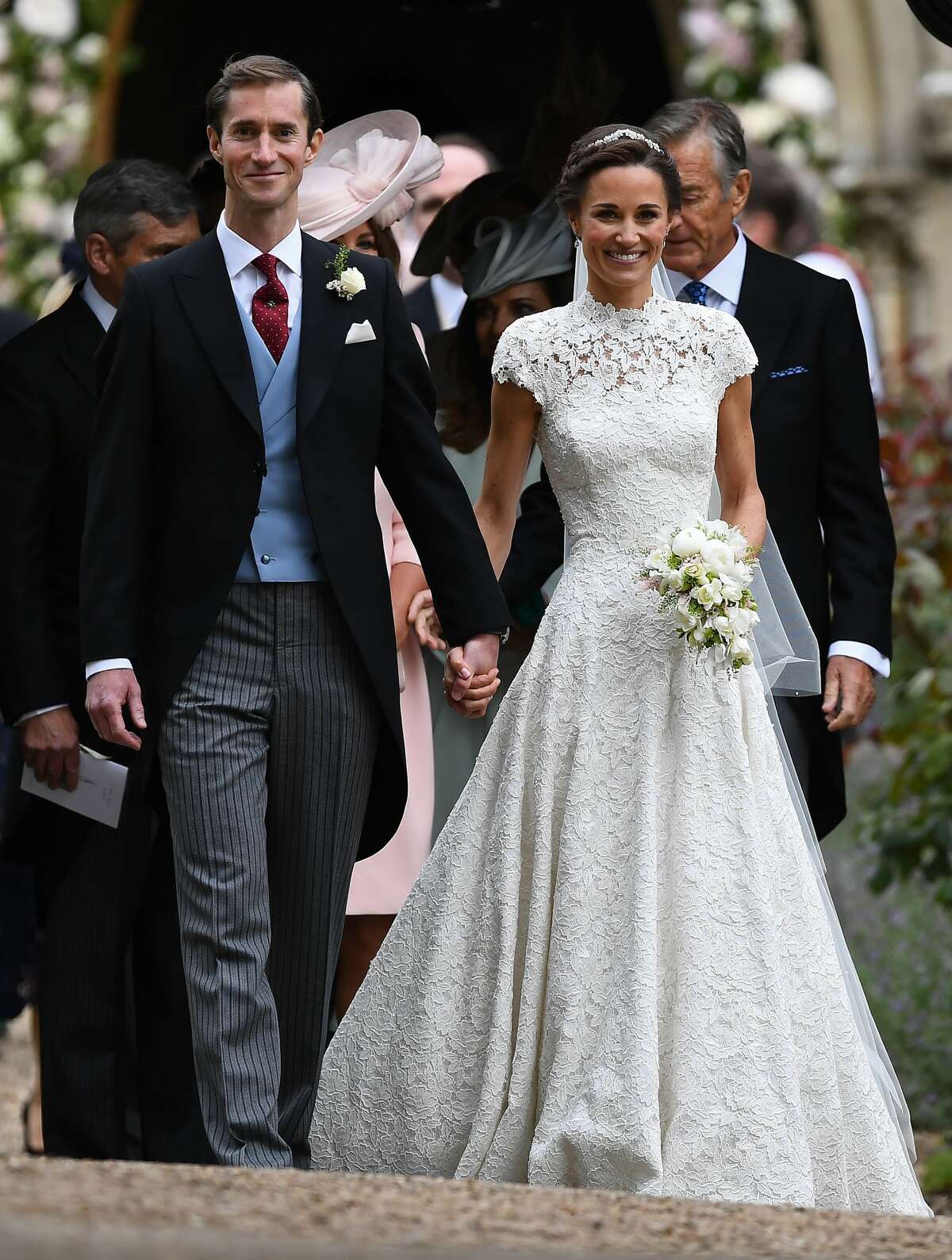 Pippa Middleton and her new husband James Matthews leave church following their wedding ceremony at St Mark's Church as the bridesmaids and pageboys walk ahead on May 20, 2017 in Englefield Green, England.