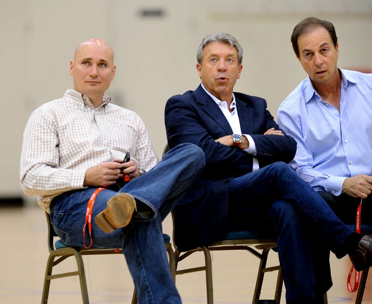 Warriors executives watch a workout session at his team's practice facility on Sunday, June 5, 2011, in Oakland, Calif. From left to right are director of player personnel Travis Schlenk, general manager Larry Riley and team owner Joe Lacob.