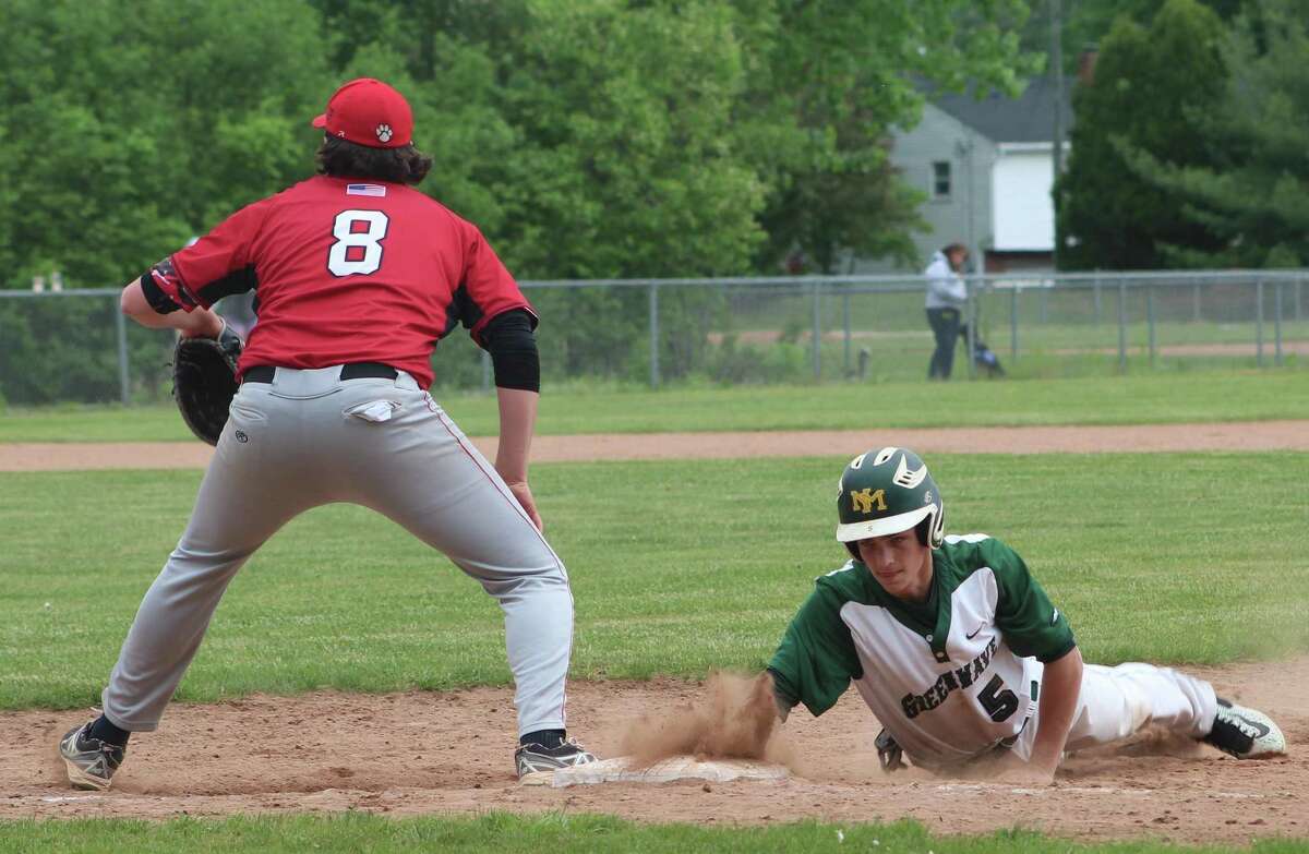 New Milford's Zachary Prahach, right, dives safely back to first base as Pomperaug's Will McDonald awaits the a pick-off throw during the South-West Conference baseball quarterfinal game at New Milford High School May 20, 2017.
