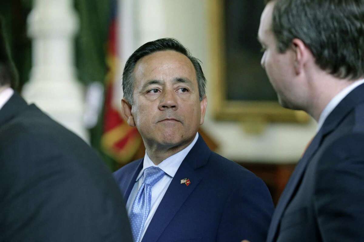 State Sen. Carlos Uresti gets some advice from his staff as he makes it back to the floor of the Senate chamber after being arrested on federal fraud and bribery charges Wednesday morning.