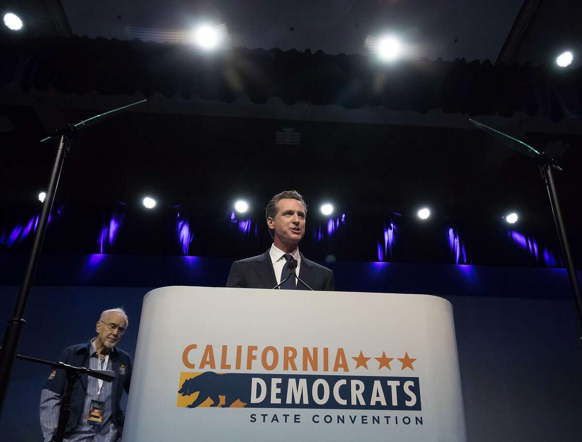 Lt. Gov. Gavin Newsom speaks at the California Democratic Party’s state convention in Sacramento. Behind him is Democratic Party Chairman John Burton.