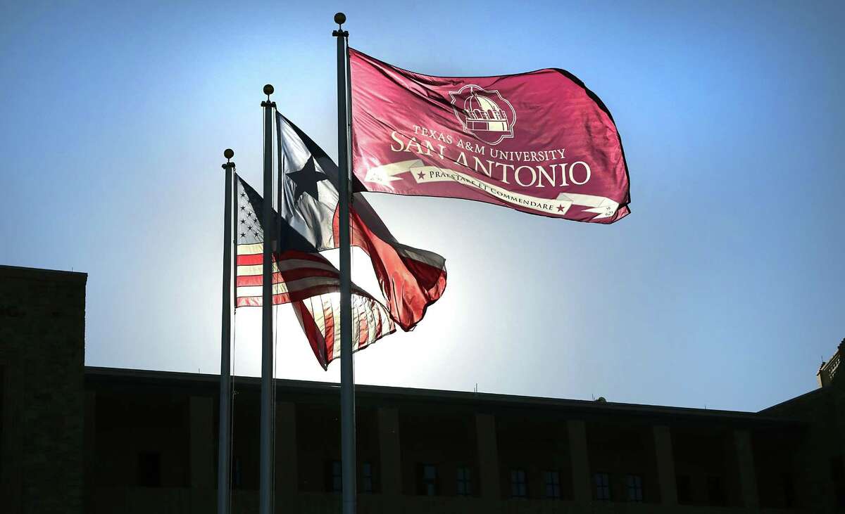 The flags of the U.S., Texas, and Texas A&M San Antonio fly over the entrance to the campus which is expanding to have residential halls. Friday, Oct. 21, 2016.