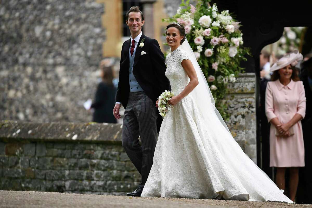 Pippa Middleton, right and James Matthews walk, after their wedding at St Mark's Church in Englefield, England, Saturday, May 20, 2017. Middleton, the sister of Kate, Duchess of Cambridge married hedge fund manager James Matthews in a ceremony Saturday where her niece and nephew Prince George and Princess Charlotte was in the wedding party, along with sister Kate and princes Harry and William. (Justin Tallis/Pool Photo via AP)