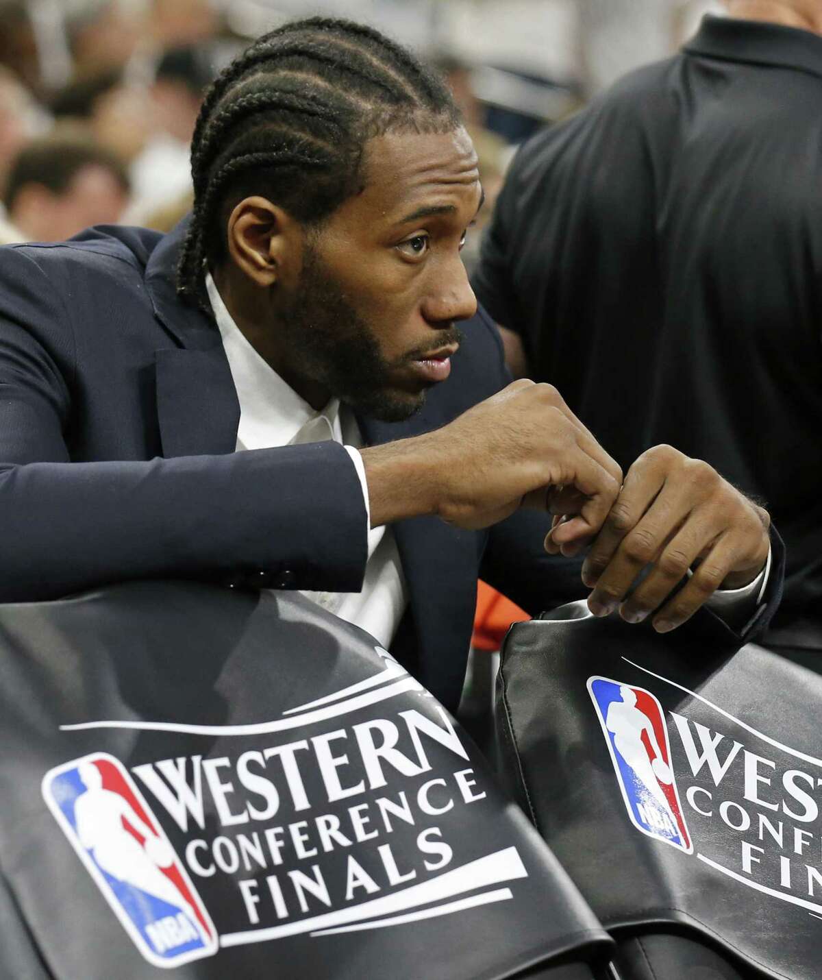 Kawhi Leonard, who was held out of Game 3 on Saturday, sits behind the bench and watches. Leonard has been out since the second half of Game 1.
