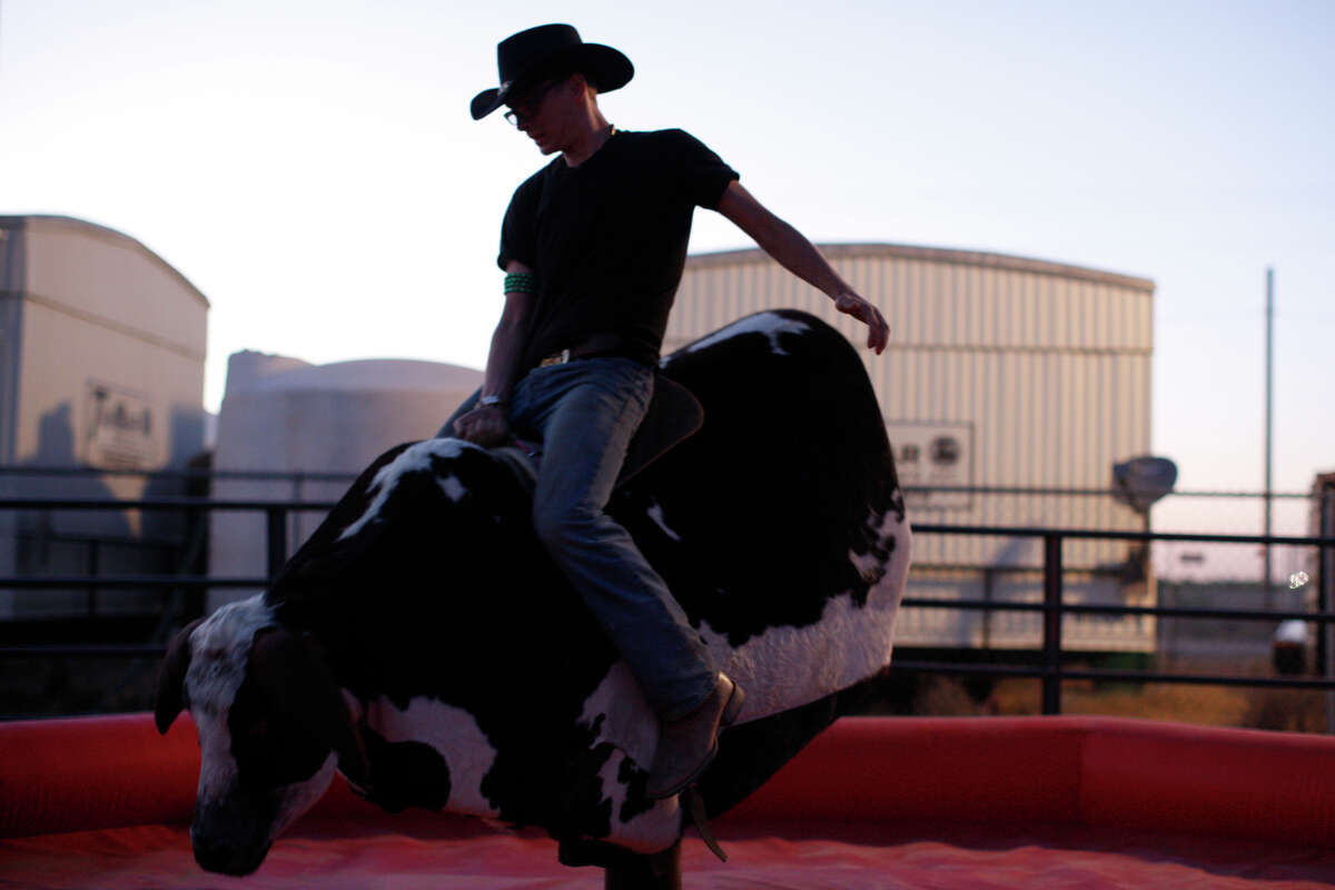 A concert attendee rides a mechanical bull during the Crudefest country music festival May 20, 2017. James Durbin/Reporter-Telegram