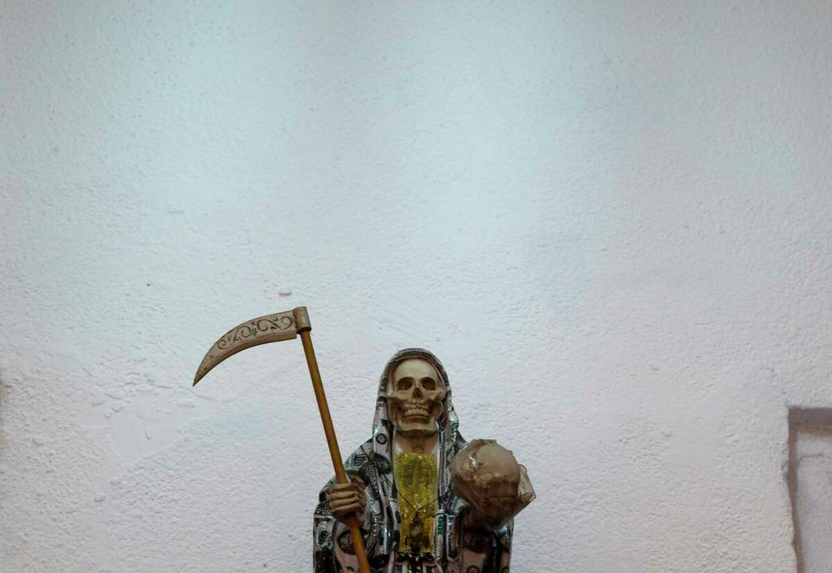 Santa Muerte wears a cloak of U.S. dollar bills. Usually clad in colored robes, it also is common for her to be dressed as a bride or in nun's garments.
