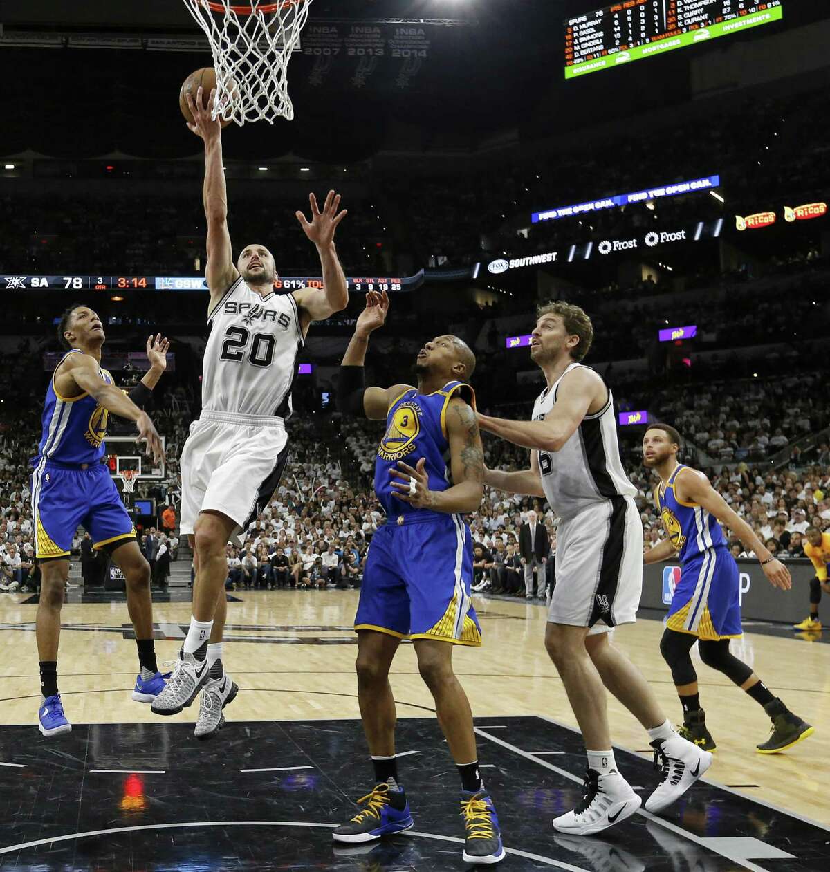 San Antonio Spurs' Manu Ginobili shoots between Golden State Warriors' Patrick McCaw (left) and David West as San Antonio Spurs' Pau Gasol and Golden State Warriors' Stephen Curry look on during second half action in Game 3 of the Western Conference Finals held Saturday May 20, 2017 at the AT&T Center. The Warriors won 120-108.