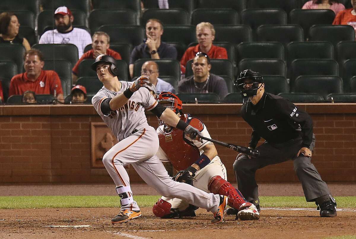 San Francisco Giants' Christian Arroyo drives in two runs with a double in the 13th inning during a baseball game against the St. Louis Cardinals Saturday, May 20, 2017, in St. Louis. At right are Cardinals catcher Yadier Molina and home plate umpire Vic Carapazza. (Chris Lee/St. Louis Post-Dispatch via AP)