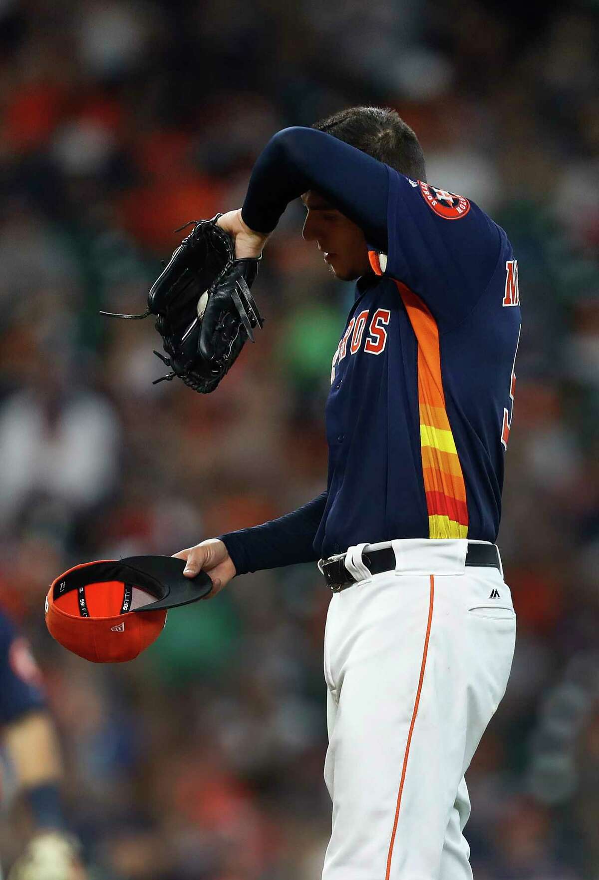 Houston Astros starting pitcher Joe Musgrove (59) wipes his brow as manager A.J. Hinch walked out to the mound to retrieve him during the fourth inning of an MLB baseball game at Minute Maid Park, Sunday, May 21, 2017.