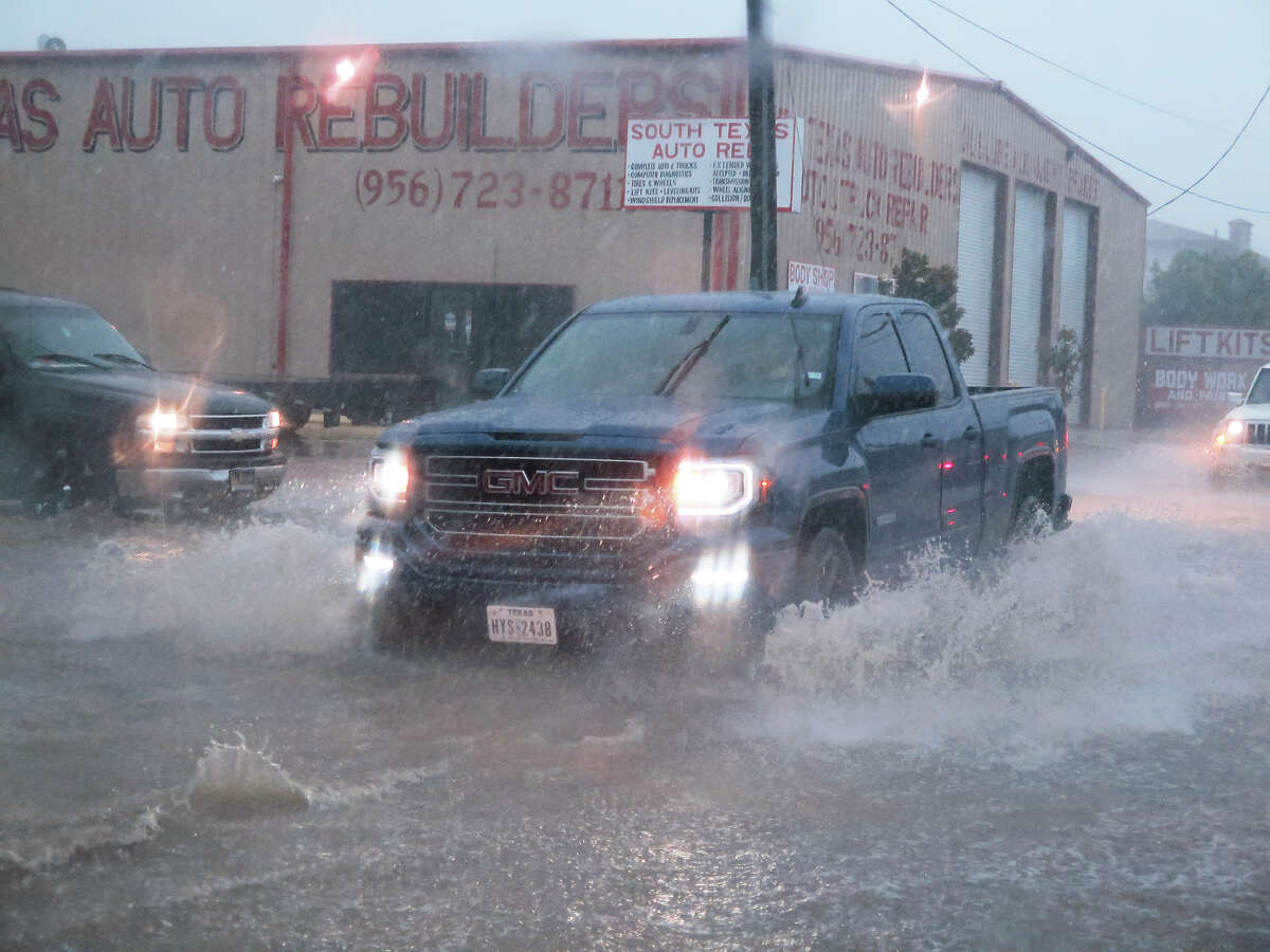 A motorist drives into a flooded intersection on Arkansas Avenue and Guadalupe Street as a severe storm hits the area Sunday, May 21, 2017. The storm brought heavy rain, hail and strong wind gusts.
