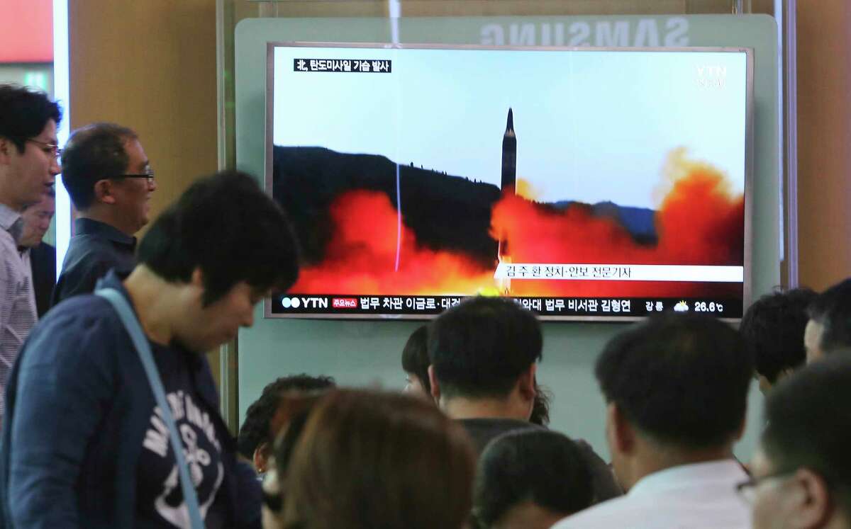 People watch a TV news program showing a file image of a missile launch by North Korea, at the Seoul Railway Station in Seoul, South Korea, Sunday, May 21, 2017. North Korea on Sunday fired a midrange ballistic missile, U.S. and South Korean officials said, in the latest weapons test for a country speeding up its development of nuclear weapons and missiles. (AP Photo/Ahn Young-joon)