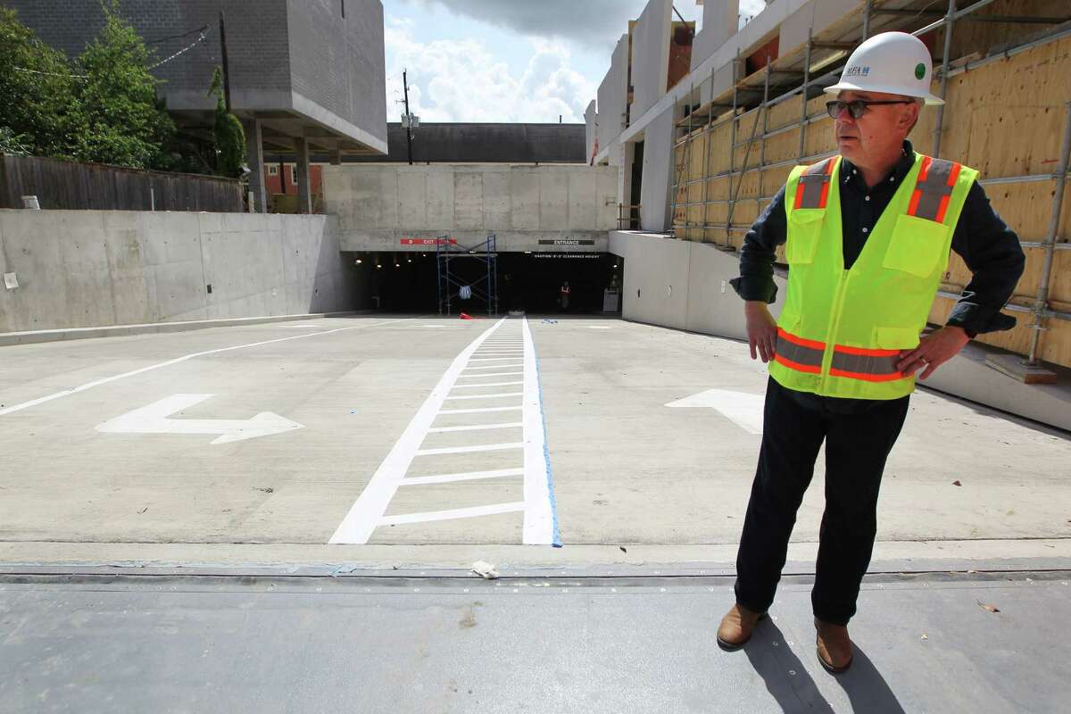 Willard Holmes, the chief operating officer of the Museum of Fine Arts, Houston, stands atop the new parking garage at 5101 Montrose. Near his feet is a flood gate that responds to water pressure.