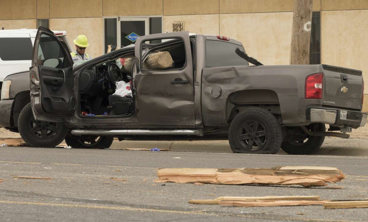 Midland Police investigate a fatal accident 5/22/17 morning in the 1800 block of Garden City Hwy after a Chevy pickup collided with a truck carrying utility poles. Red caution tape on the poles is still visible following the accident. Tim Fischer/Reporter-Telegram