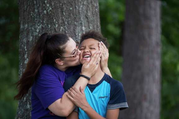 Nicole Rechner surprises her son Demarcus Fuller, 12, with a kiss at the Tidwell Park, Saturday, May 20, 2017, in Houston. Rechner transferred him to HISD's Hamilton Middle School where he now receives appropriate special education services after years of being denied the services.