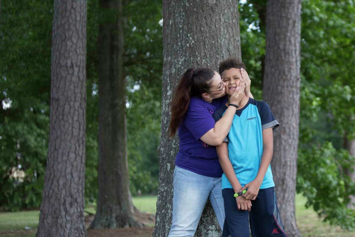 Nicole Rechner kisses her son Demarcus Fuller, 12, at the Tidwell Park, Saturday, May 20, 2017, in Houston. Rechner transferred him to HISD's Hamilton Middle School where he now receives appropriate special education services after years of being denied the services.
