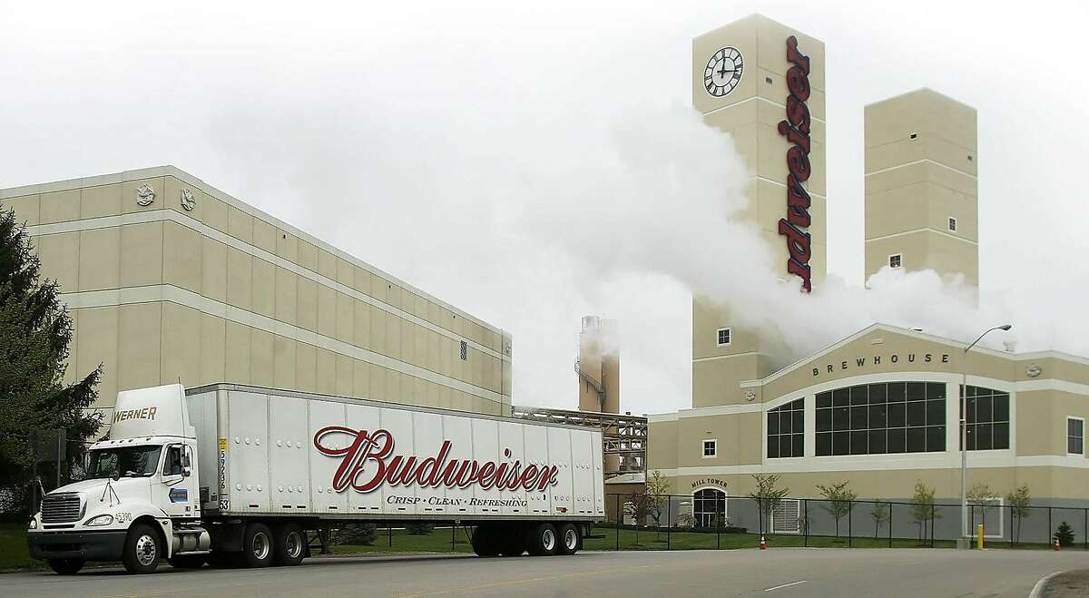 A Budweiser truck drives out of the Anheuser-Busch Brewery parking lot in front of the brewhouse and mill tower Thursday April 21, 2005, in Columbus, Ohio. Anheuser-Busch Cos., the world's largest brewer, plans to toast the New Year with higher prices for Budweiser and Michelob. Pepsi Bottling Group Inc. may drink to that too. Photographer: Jay LaPrete/Bloomberg News.