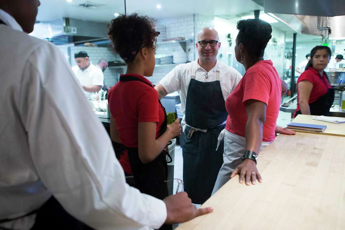 Seth Siegel-Gardner, chef/co-owner of the Pass & Provisions restaurant speaks to Kellie Karavias, center, a culinary arts educator at Gregory-Lincoln Education Center and Karavias' student Zaeria Hamilton, 13, at a classroom exercise at the restaurant.