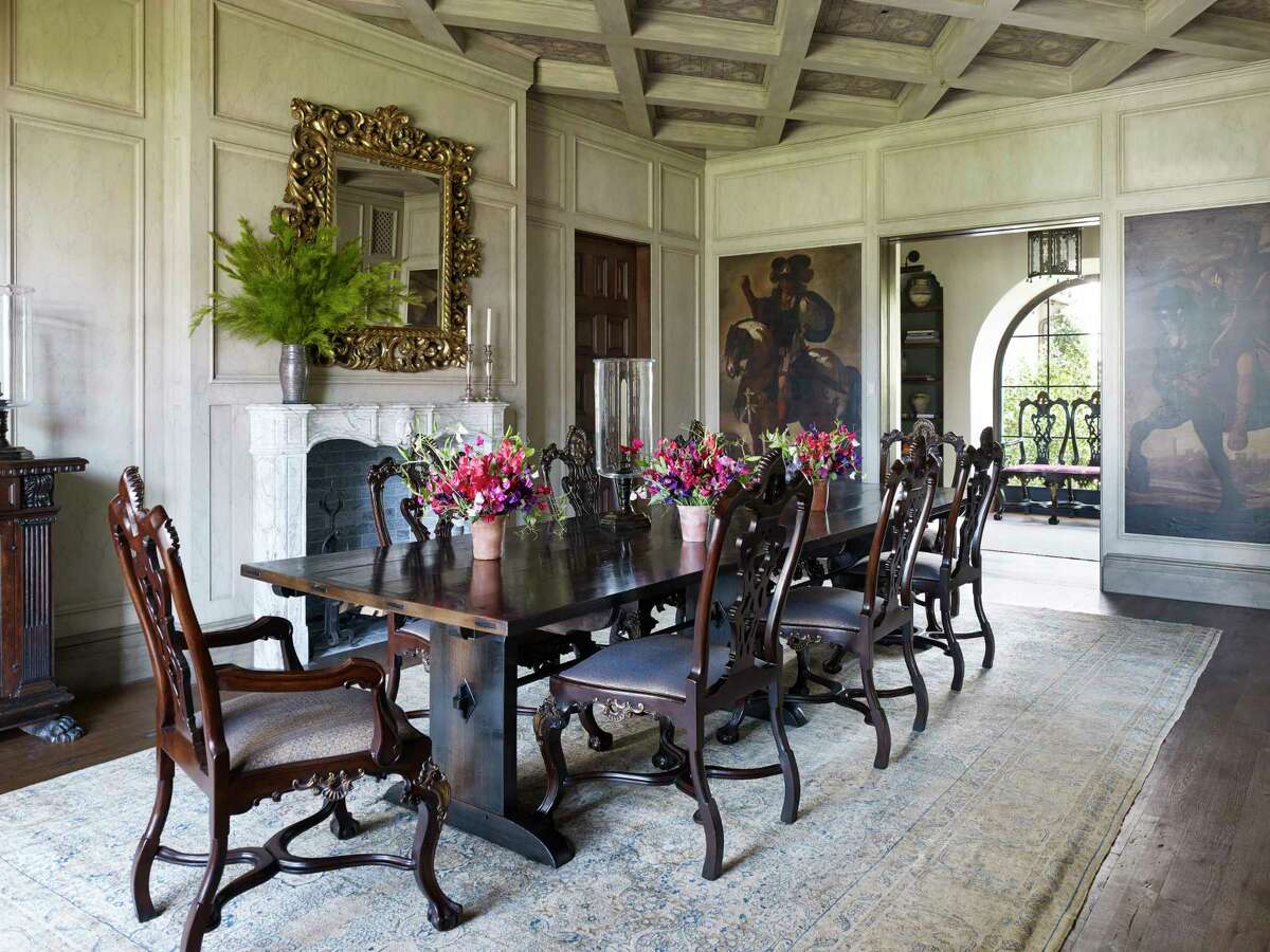 The dining room walls and ceiling in this Santa Monica, Calif., Spanish Revival home were hand-painted by Maria Trimbell using a crackle-varnish finish. Seventeenth-century Spanish portraits of Roman generals are set into panels and joined by a nineteenth-century gilt-wood mirror.