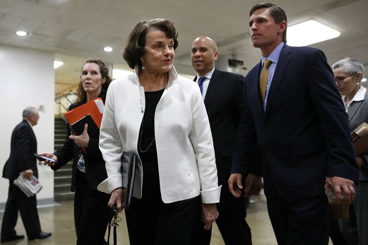 Sen. Dianne Feinstein, D-Calif., left, walks with Sen. Cory Booker, D-N.J., center, and Sen. Martin Heinrich, D-N.M., on Capitol Hill in Washington, Thursday, May 18, 2017, to attend a closed-door briefing of the full Senate by Deputy Attorney General Rod Rosenstein amid controversy over President Donald Trump's firing of FBI Director James Comey. (AP Photo/Jacquelyn Martin)
