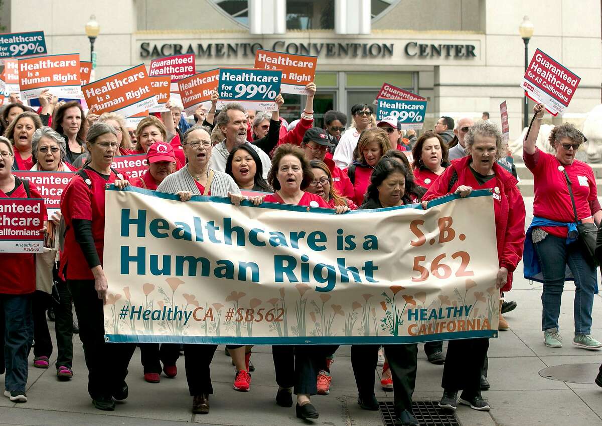 Supporters of single-payer health care march to the Capitol Wednesday, April 26, 2017, in Sacramento, Calif. The bill, SB562 by Democratic state Sens. Ricardo Lara, of Bell Gardens, and Toni Atkins, of San Diego, that would guarantee health coverage with no out-of-pocket cost for all California residents, including people living in the country illegally is to be heard in the Senate Health Committee, Wednesday. (AP Photo/Rich Pedroncelli)