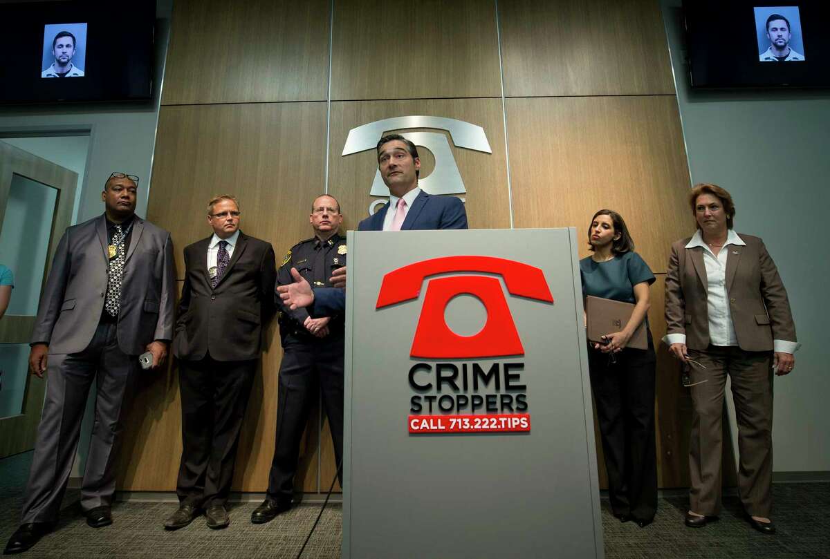 Harris County District Attorney's Vehicular Crimes Unit Chief Sean Teare, center, talks with media about the arrests of two suspects wanted in separate fatal hit-and-run cases during a press conference at the Crime Stoppers of Houston building on May 19, 2017, in Houston. (Godofredo A. Vasquez / Houston Chronicle)