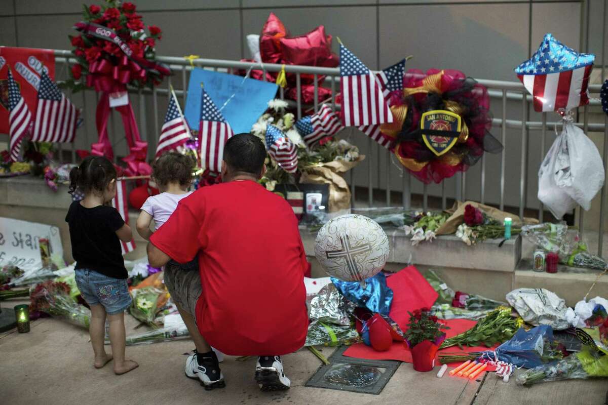 Mourners continue to pay their respects to San Antonio Fire Department firefighter Scott Deem at a memorial outside the Public Safety Building downtown.