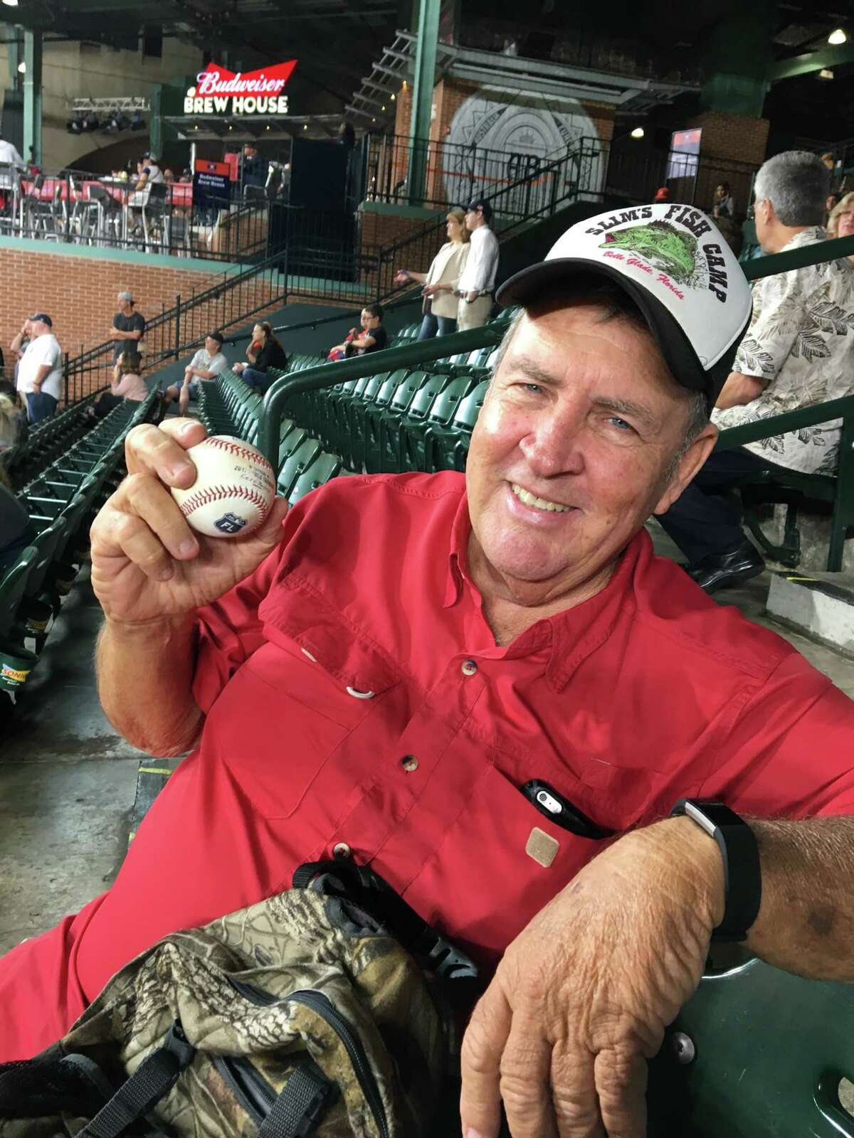 Jerry Peacock shows off the ball his son Brad gave him after warming up in the bullpen Monday night.