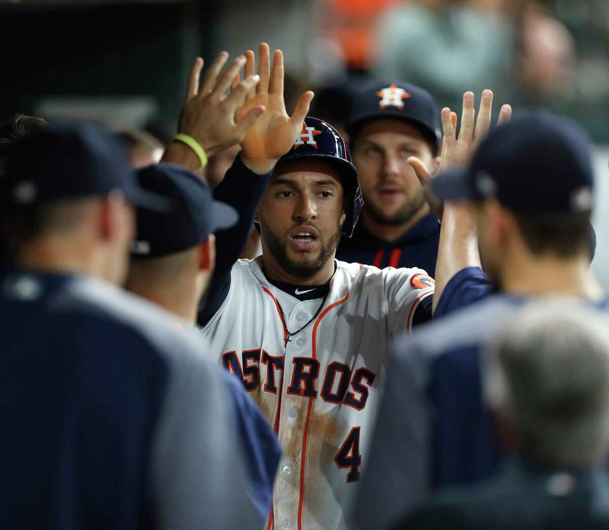 Houston Astros center fielder George Springer (4) celebrates his run scored on Houston Astros second baseman Jose Altuve's RBI double during the first inning of an MLB baseball game at Minute Maid Park, Monday, May 22, 2017. ( Karen Warren / Houston Chronicle )