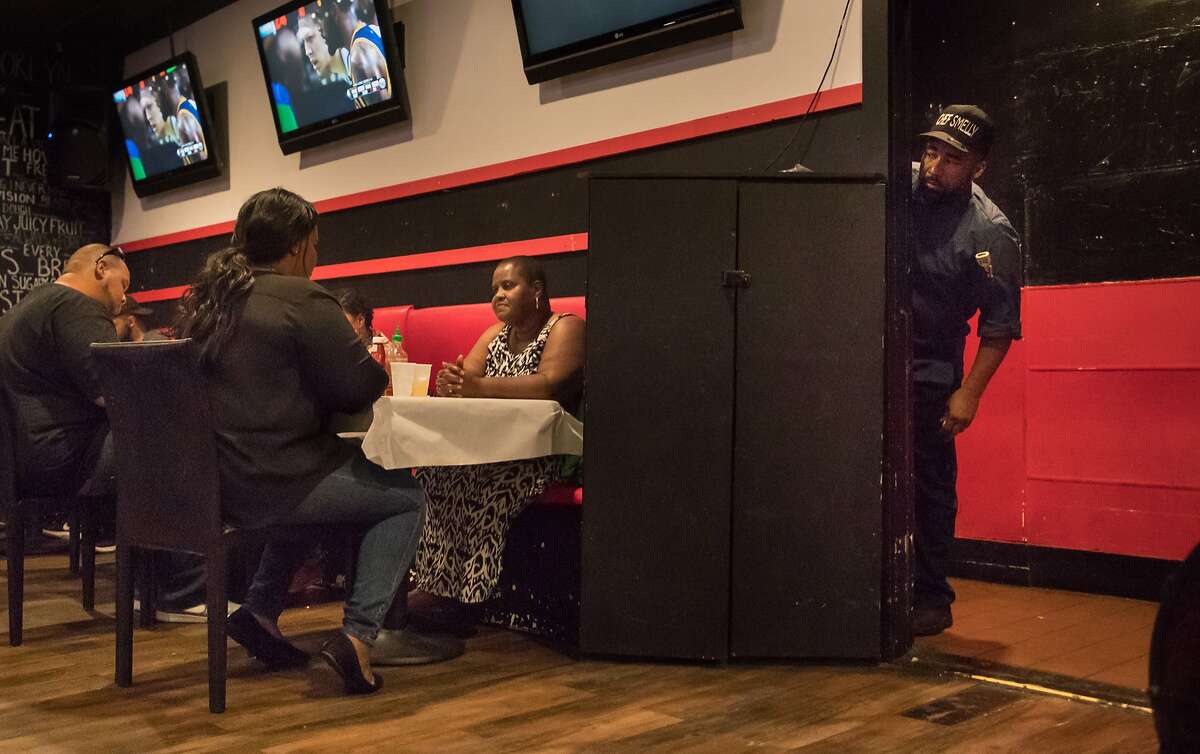 Edward Wooley (Chef Smelly) checking out the crowd on Friday, May 19, 2017 in Oakland, Calif. Seated at left is Jay Lowe with his wife Peppers, Whitley Donsereaux taking out her mom from New Orleans (originally from Oakland) Ackie.
