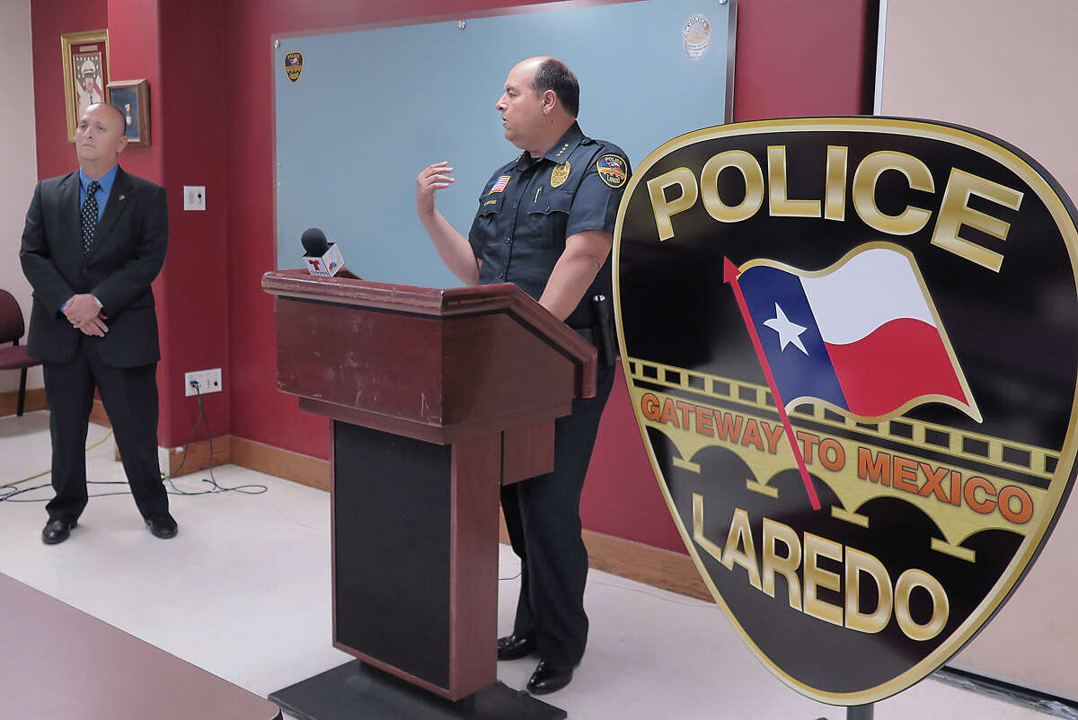 Laredo Police department PIO Joe Baeza, left, listens as acting Chief of Police Gabriel Martinez addresses members of the media, Monday, May 22, 2017 at the Laredo Police Department's Briefing Room, about an officer involved shooting incident.