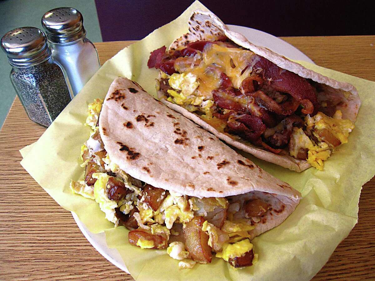 Potato and egg taco, foreground, and the Teran's Special Taco (eggs, beans, bacon, ham, sausage, potatoes and cheese), both on handmade flour tortillas, from Teran's Restaurant.