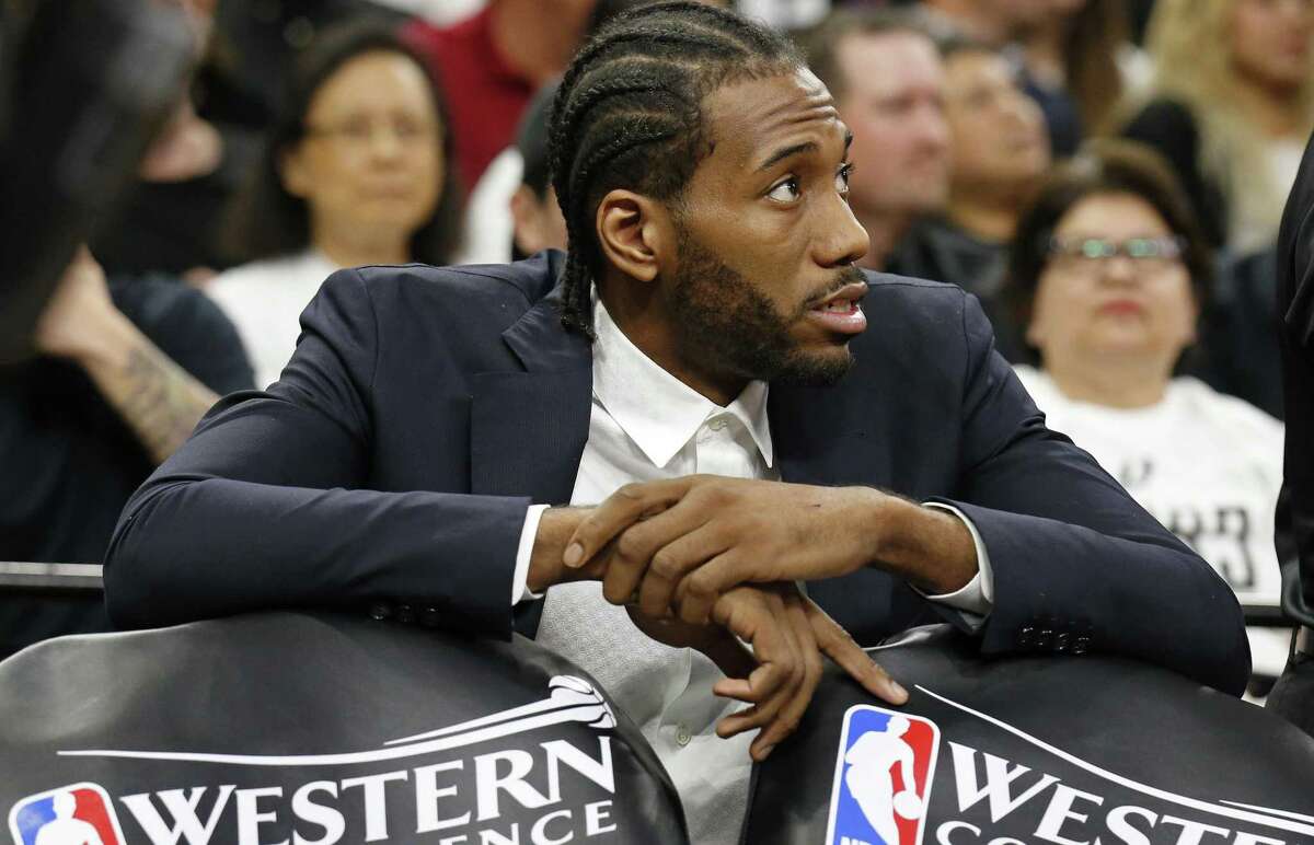 Spurs’ Kawhi Leonard sits behind the bench during a timeout in first half action of Game 3 in the Western Conference finals against the Golden State Warriors on May 20, 2017 at the AT&T Center.