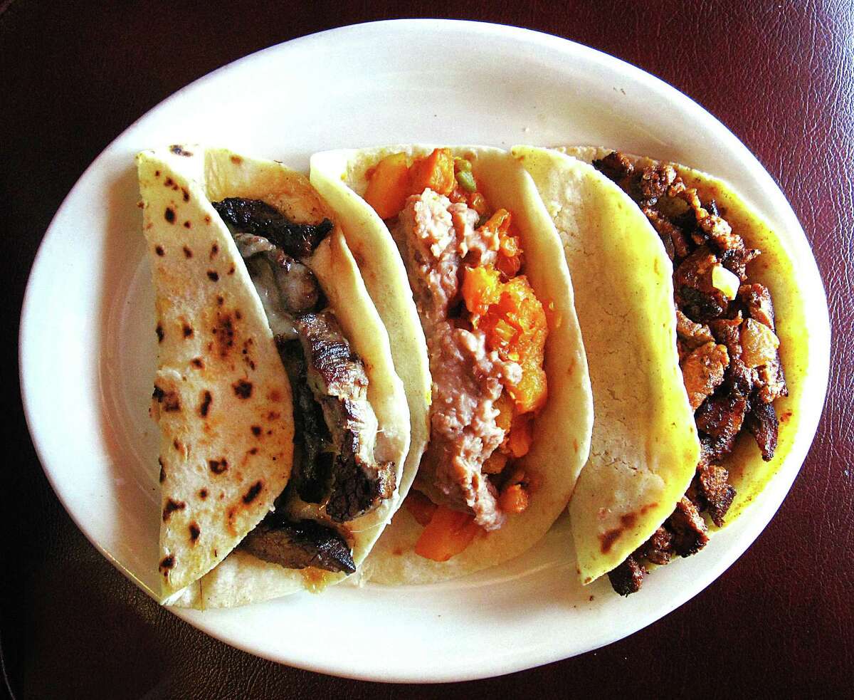 From left: beef fajita quesadilla, papas rancheras with beans and al pastor tacos from Taquería Aguascalientes.