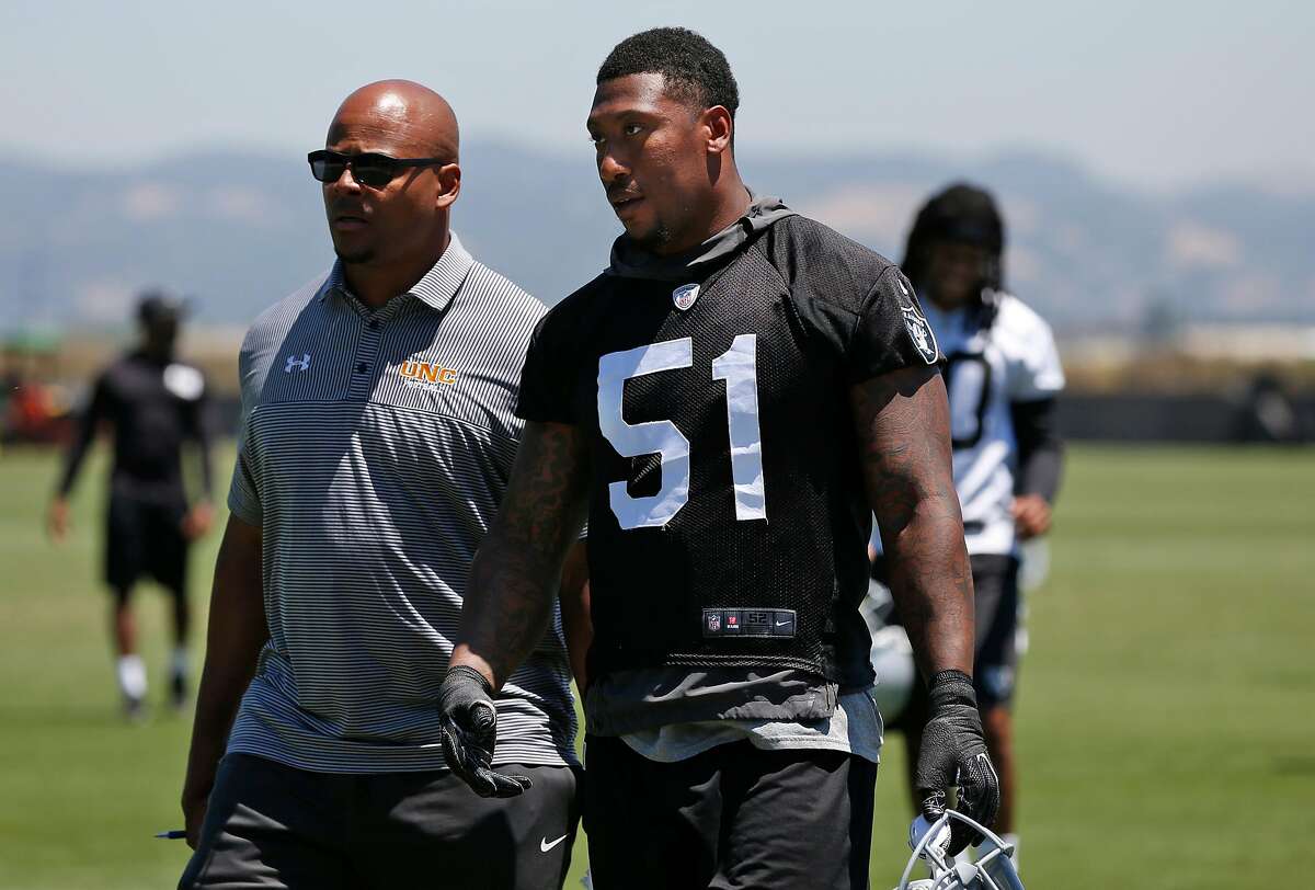 Bruce Irvin, 51, chats while walking off the field after practice at the Oakland Raiders facility May 23, 2017 in Alameda, Calif.