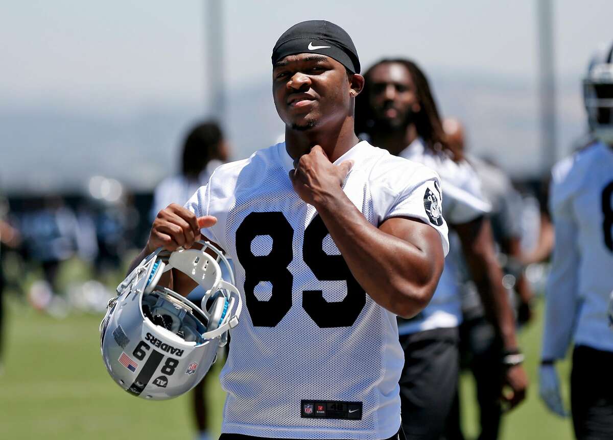 Amari Cooper reaches to take his practice jersey off after practice at the Oakland Raiders facility May 23, 2017 in Alameda, Calif.