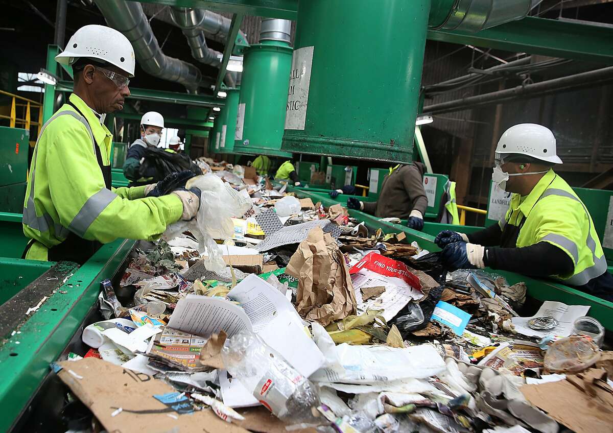 Classifiers work on removing non recyclable materials at Recology recycling plant on Pier 96 on Friday, May 19, 2017, in San Francisco, Calif.