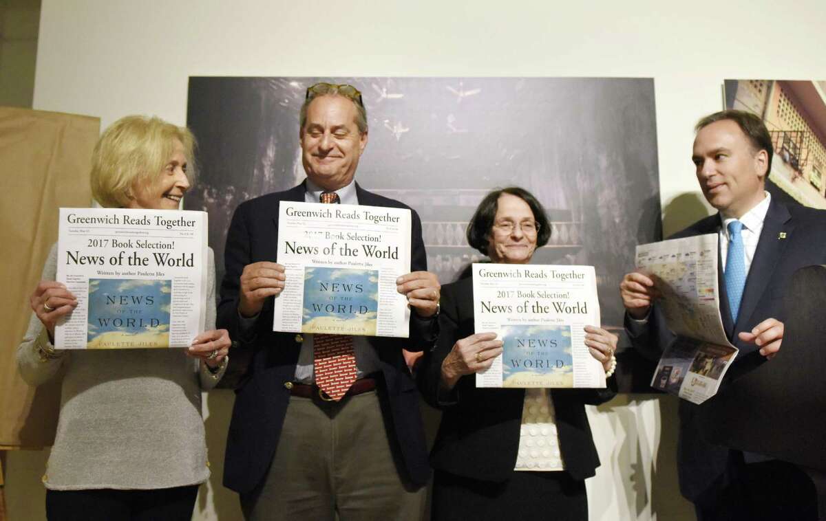 From left, Friends of Greenwich Library Chair Sharon Fortenbaugh, Greenwich Library Board of Trustees President Chip Haslun, Greenwich Library Director Barbara Ormerod-Glynn, and Greenwich First Selectman Peter Tesei unveil the 2017 Greenwich Reads Together book "News of the World" at Greenwich Library in Greenwich, Conn. Tuesday, May 23, 2017. The 2016 novel "News of the World," by Paulette Jiles, was chosen as the book for the community-wide reading experience. The middle school companion book chosen was "The Ransom of Mercy Carter," by Caroline B. Cooney, and the elementary school companion chosen was "The Girl Who Loved Wild Horses," by Paul Goble.