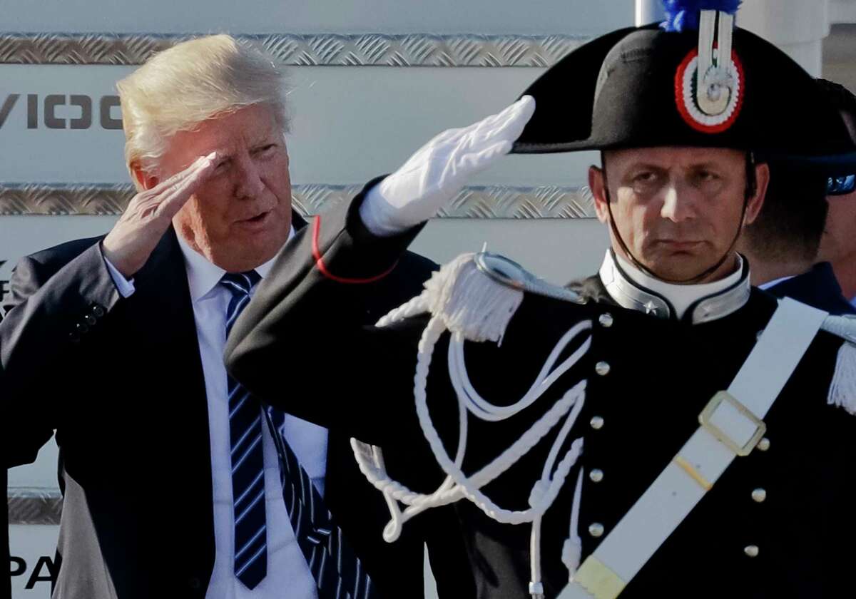 US President Donald Trump salutes a Carabinieri paramilitary officer upon his arrival at Fiumicino's Leonardo Da Vinci International airport, near Rome, Tuesday, May 23, 2017. Trump is in Italy for a two day visit, including a meeting with Pope Francis at the Vatican, ahead of his participation in a NATO meeting in Brussels on Thursday. (AP Photo/Andrew Medichini)